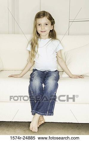 Stock Photography - Girl sitting on a couch. Fotosearch