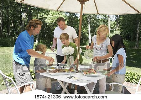 Stock Photograph - Group of people standing in a garden. Fotosearch