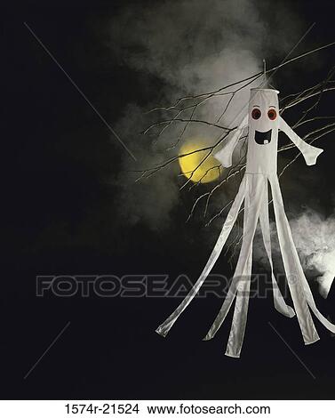 Halloween decoration hanging from a tree View Large Photo Image Picture - Halloween decoration hanging from a tree. Fotosearch