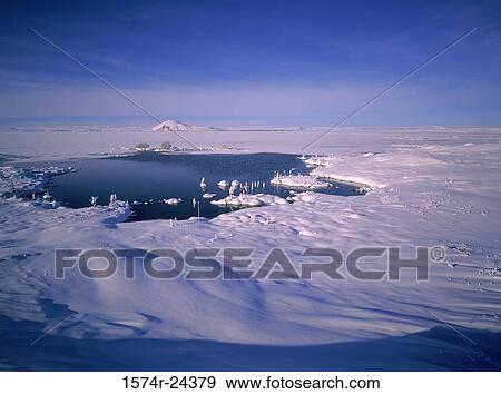 High angle view of a lake on a polar landscape with a mountain in the background, Mount Vindbelgur, Lake Myvatn, Iceland View Large Photo Image Stock Photo - High angle view of a lake on a polar landscape with a mountain in the background, Mount Vindbelgur, Lake Myvatn, Iceland. Fotosearch