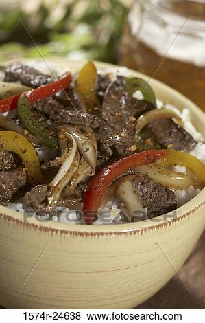 High angle view of beef and peppers on rice in a bowl View Large Photo Image Stock Photo - High angle view of beef and peppers on rice in a bowl. Fotosearch