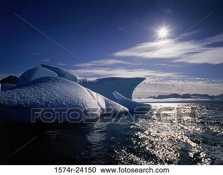 Stock Image - Iceberg floating on water, Greenland. Fotosearch