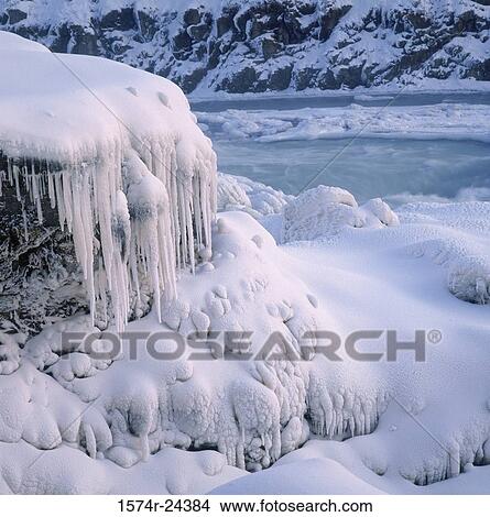 Icicles on a snow covered cliff, Gullfoss Falls, Iceland View Large Photo Image Picture - Icicles on a snow covered cliff, Gullfoss Falls, Iceland. Fotosearch