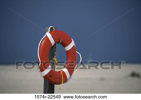 Life preserver hanging on a wooden post View Large Photo Image Stock Photo - Life preserver hanging on a wooden post. Fotosearch