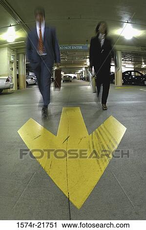 Low angle view of a businessman and a businesswoman walking View Large Photo Image Stock Image - Low angle view of a businessman and a businesswoman walking. Fotosearch