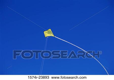 Low angle view of a kite flying in sky View Large Photo Image Stock Image - Low angle view of a kite flying in sky. Fotosearch