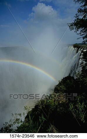 Low angle view of a rainbow over a waterfall, Victoria Falls, Zambia-Zimbabwe Border View Large Photo Image Stock Photograph - Low angle view of a rainbow over a waterfall, Victoria Falls, Zambia-Zimbabwe Border. Fotosearch