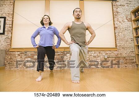 Low angle view of a young couple exercising View Large Photo Image Stock Photo - Low angle view of a young couple exercising. Fotosearch