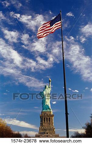 Low angle view of an American flag near a statue, Statue of Liberty, New York City, New York, USA View Large Photo Image Stock Photo - Low angle view of an American flag near a statue, Statue of Liberty, New York City, New York, USA. Fotosearch