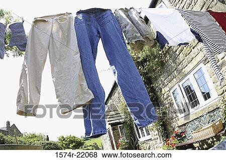 Low angle view of clothes drying on a clothes line View Large Photo Image Stock Photo - Low angle view of clothes drying on a clothes line. Fotosearch