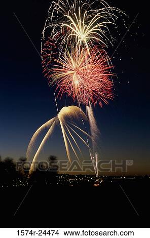 Low angle view of fireworks display at night in a city View Large Photo Image Picture - Low angle view of fireworks display at night in a city. Fotosearch