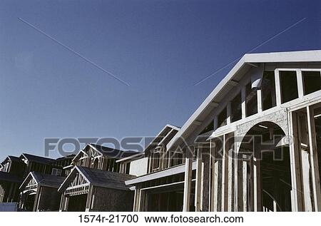 Stock Image - Low angle view of the wooden framework of a house under construction. Fotosearch