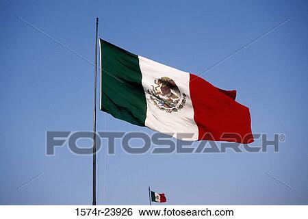 Stock Photograph - Low angle view of two Mexican flags. Fotosearch