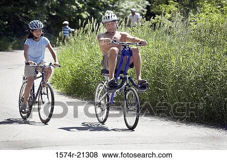 Mature man and his daughter cycling View Large Photo Image Stock Photo - Mature man and his daughter cycling. Fotosearch