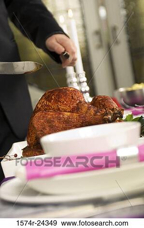 Mid section view of a man holding a knife and fork near a roasted turkey View Large Photo Image Stock Photo - Mid section view of a man holding a knife and fork near a roasted turkey. Fotosearch