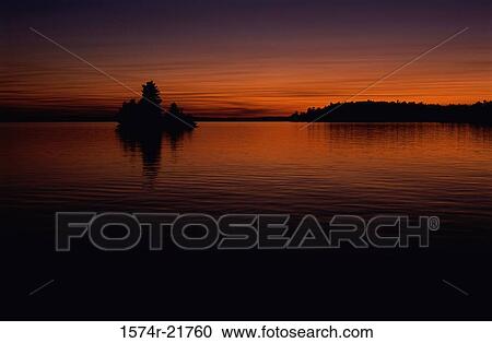 Panoramic view of a lake during a sunset View Large Photo Image Stock Image - Panoramic view of a lake during a sunset. Fotosearch