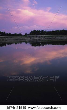 Panoramic view of a lake during sunset View Large Photo Image Stock Photo - Panoramic view of a lake during sunset. Fotosearch
