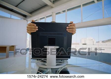 Person adjusting a computer monitor in an office View Large Photo Image Picture - Person adjusting a computer monitor in an office. Fotosearch