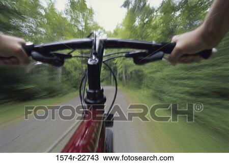 Stock Image - Person riding a bicycle. Fotosearch