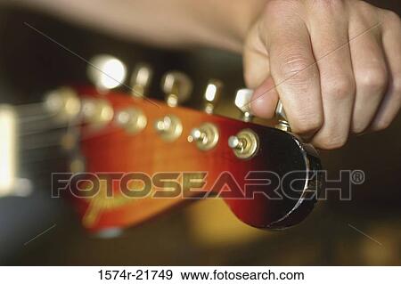 Person tuning the guitar View Large Photo Image Stock Photo - Person tuning the guitar. Fotosearch