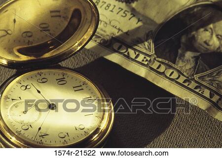 Stock Image - Pocket watch near American dollar bills. Fotosearch