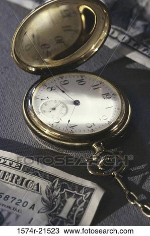 Pocket watch near American dollar bills View Large Photo Image Stock Image - Pocket watch near American dollar bills. Fotosearch
