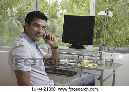Stock Image - Portrait of a businessman talking on a mobile phone. Fotosearch