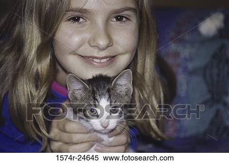 Portrait of a girl holding a kitten View Large Photo Image Stock Photography - Portrait of a girl holding a kitten. Fotosearch