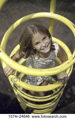 Portrait of a girl playing at a playground View Large Photo Image Stock Photograph - Portrait of a girl playing at a playground. Fotosearch