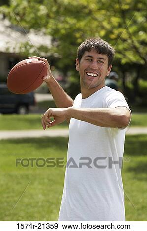 Portrait of a mid adult man throwing a football View Large Photo Image Stock Photo - Portrait of a mid adult man throwing a football. Fotosearch