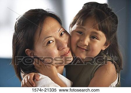 Portrait of a mid adult woman hugging her daughter View Large Photo Image Stock Photography - Portrait of a mid adult woman hugging her daughter. Fotosearch