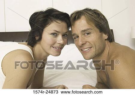 Portrait of a young couple smiling View Large Photo Image Stock Image - Portrait of a young couple smiling. Fotosearch