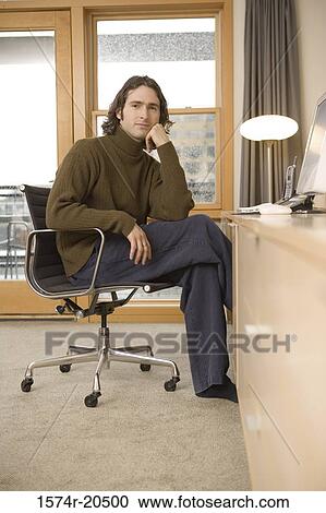 Portrait of a young man sitting in an armchair View Large Photo Image Stock Image - Portrait of a young man sitting in an armchair. Fotosearch