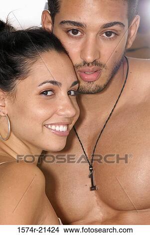 Picture - Portrait of a young man with a young woman smiling. Fotosearch