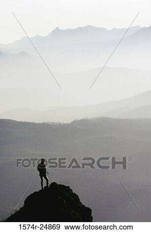 Rear view of a person standing on the mountain peak, Saddle Mountain State Natural Area, Oregon, USA View Large Photo Image Stock Photo - Rear view of a person standing on the mountain peak, Saddle Mountain State Natural Area, Oregon, USA. Fotosearch