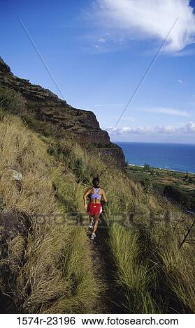 Rear view of a woman running on a trail at Oahu, Hawaii, USA View Large Photo Image Stock Photograph - Rear view of a woman running on a trail at Oahu, Hawaii, USA. Fotosearch