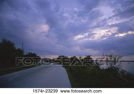 Road curving through the countryside View Large Photo Image Stock Photo - Road curving through the countryside. Fotosearch