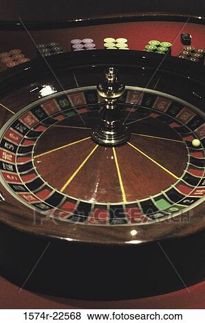 Roulette table and wheel View Large Photo Image Stock Photo - Roulette table and wheel. Fotosearch