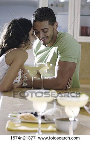 Stock Photo - Side profile of a young couple being romantic. Fotosearch