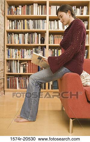 Side profile of a young woman reading a book View Large Photo Image Stock Image - Side profile of a young woman reading a book. Fotosearch