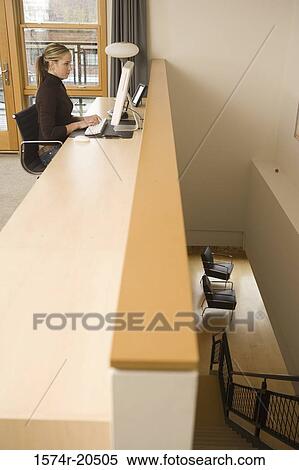 Side profile of a young woman using a computer View Large Photo Image Stock Photography - Side profile of a young woman using a computer. Fotosearch