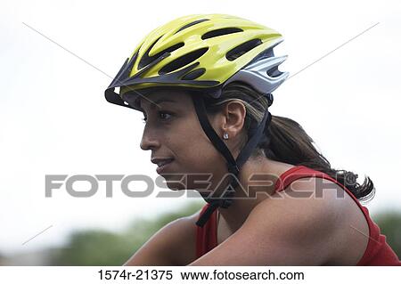 Side profile of a young woman wearing a cycling helmet View Large Photo Image Stock Photography - Side profile of a young woman wearing a cycling helmet. Fotosearch