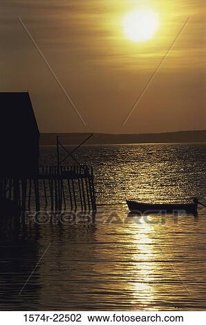 Silhouette of a boat in the sea during sunset, Clifty Cove, Nova Scotia, Canada View Large Photo Image Stock Image - Silhouette of a boat in the sea during sunset, Clifty Cove, Nova Scotia, Canada. Fotosearch