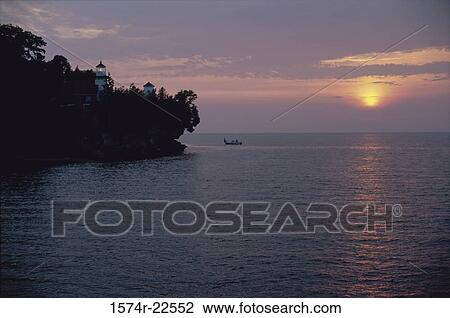 Silhouette of a boat in the sea during sunset View Large Photo Image Stock Image - Silhouette of a boat in the sea during sunset. Fotosearch