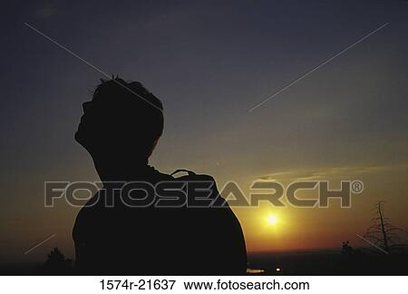 Silhouette of a man hiking during sunset View Large Photo Image Stock Photo - Silhouette of a man hiking during sunset. Fotosearch