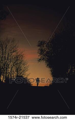 Stock Photo - Silhouette of a person cycling. Fotosearch