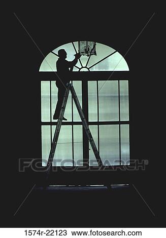 Silhouette of a person standing on a ladder View Large Photo Image Stock Image - Silhouette of a person standing on a ladder. Fotosearch