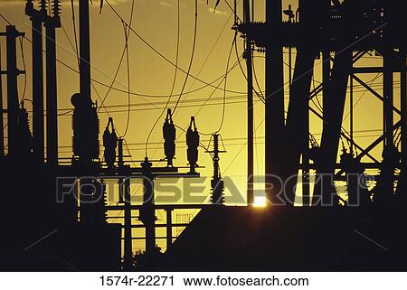 Stock Image - Silhouette of electric power pylons. Fotosearch