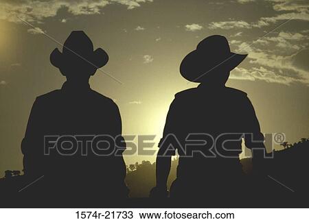 Stock Image - Silhouette of two cowboys, Grover, Colorado, USA. Fotosearch