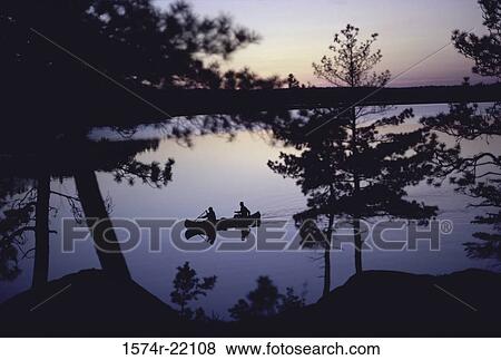 Silhouette of two people in a canoe, Canada View Large Photo Image Stock Photo - Silhouette of two people in a canoe, Canada. Fotosearch